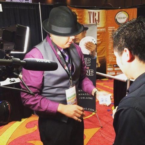 Brian Yazzie performing walk-around magic at a conference trade show