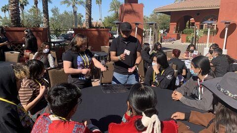 Brian Yazzie performing close-up magic at an outdoor event